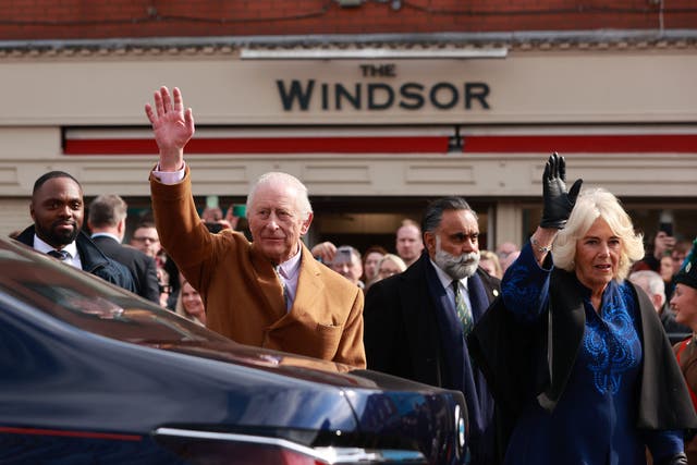 King Charles III and Queen Camilla wave to the crowd as they leave following a visit to Banbridge on day three of the royal visit to Northern Ireland. Picture date: Friday March 21, 2025.