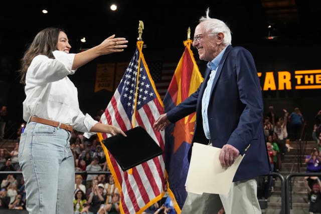 <p>New York Rep. Alexandria Ocasio-Cortez greets Vermont Senator as he arrives to speak during a ‘Fighting Oligarchy tour event at Arizona State University in Tempe on Thursday</p>