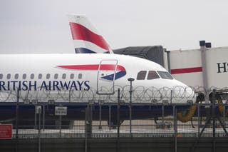 A British Airways plane is parked at Terminal 5 as Britain's Heathrow Airport has closed for the full day on Friday