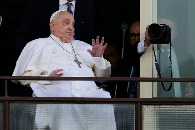 <p>Pope Francis appears on the hospital balcony before going home to the Vatican on Sunday</p>