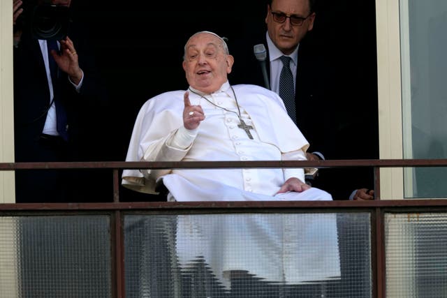 <p>Francis gestures from the window of the Gemelli hospital before his return home</p>