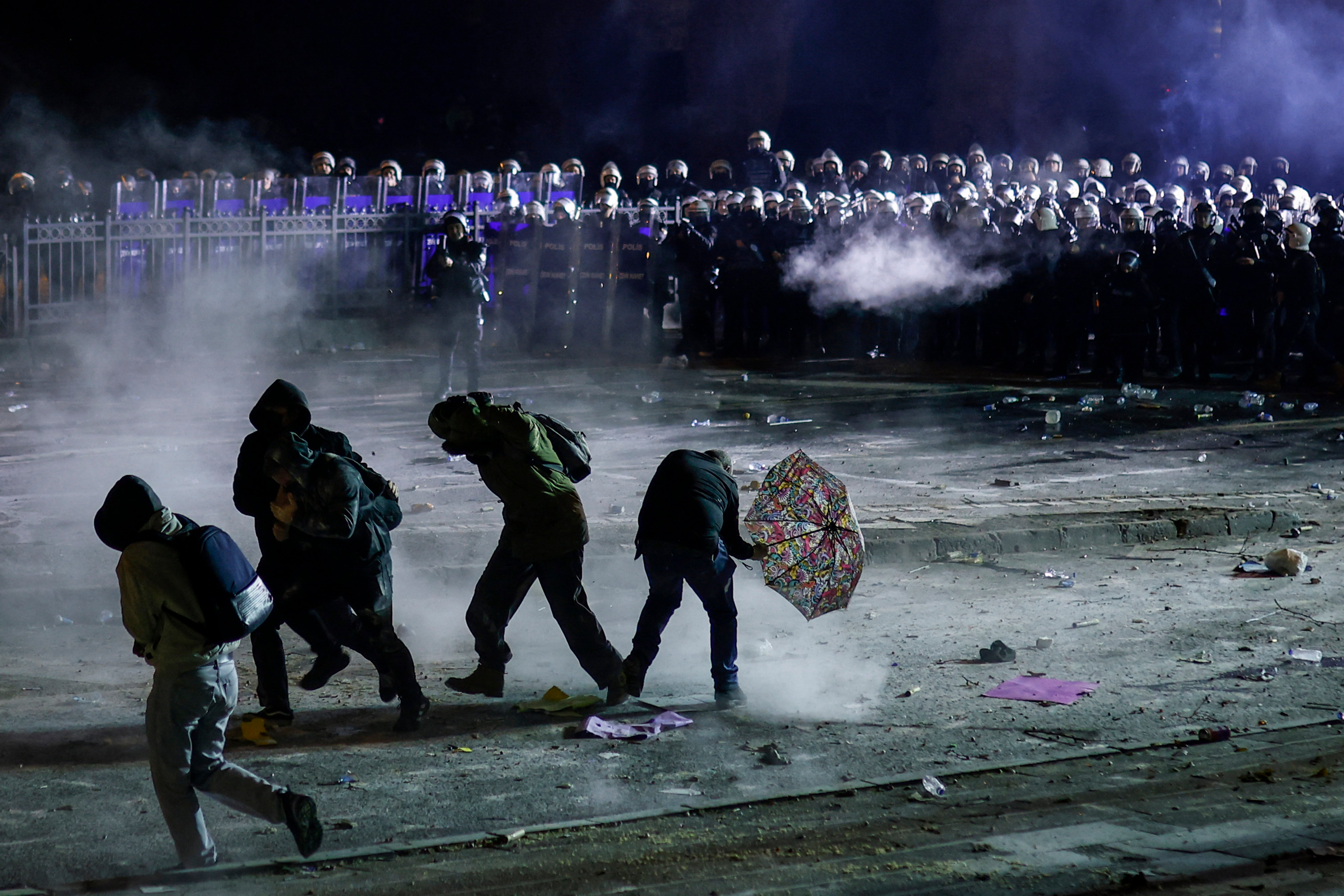 Protesters disperse as Turkish riot police use teargas during a demonstration outside Istanbul’s city hall