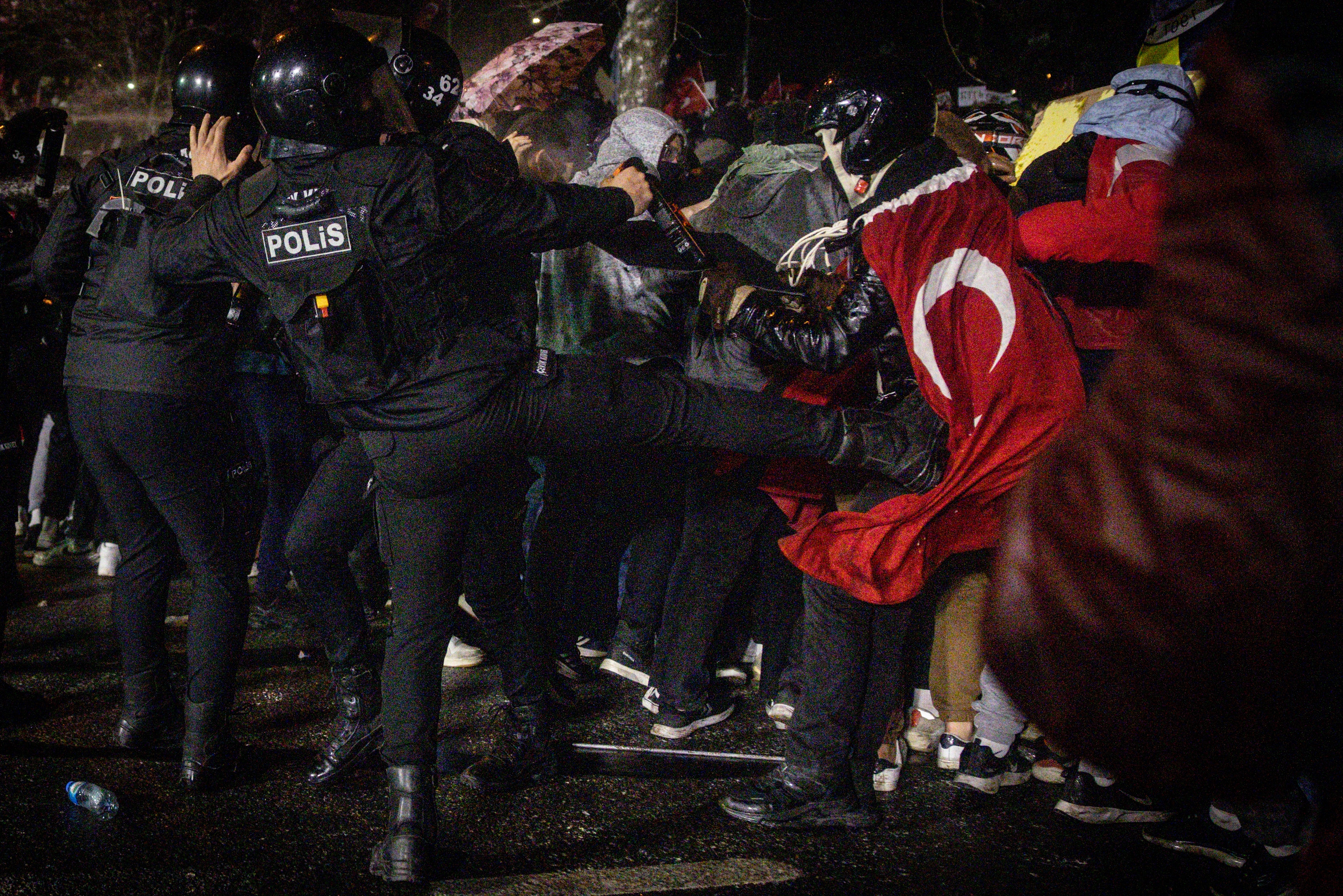 A police officer kicks a protester during clashes in front of Istanbul’s famous aqueduct at the weekend