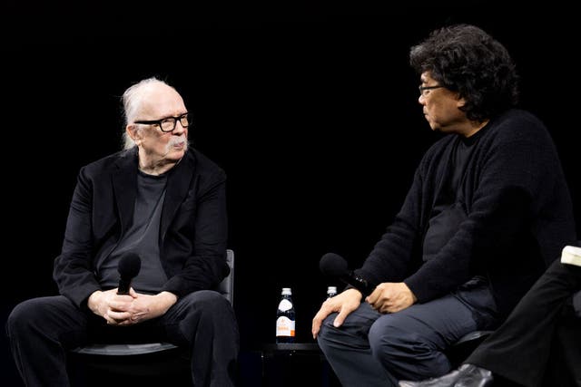 <p>John Carpenter and Bong Joon Ho speak onstage at the Academy Museum special screening of 'The Thing'</p>