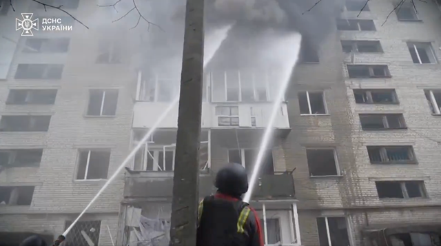 <p>Firefighters put out a fire in a residential building in Sumy on 24 March</p>