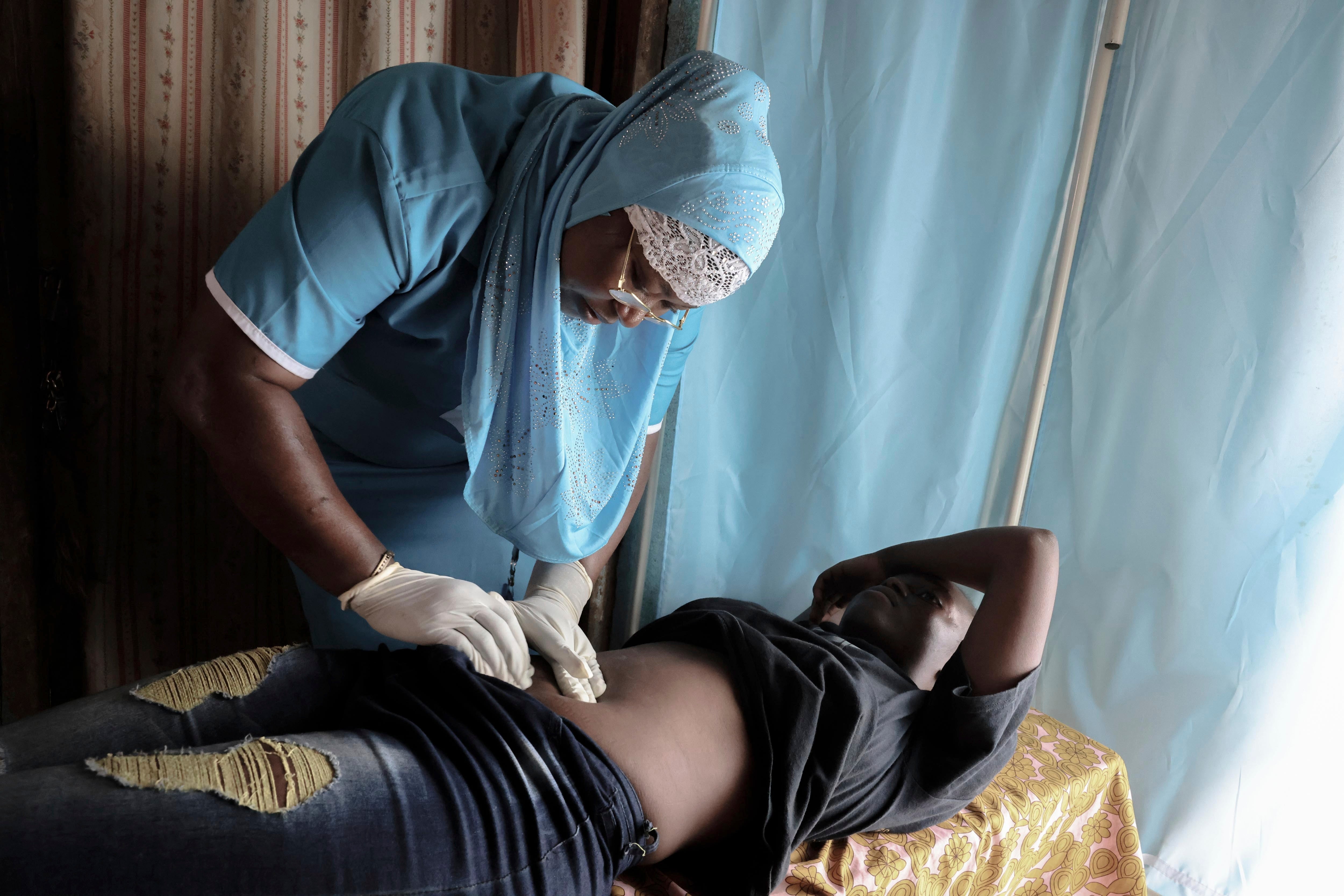 <p>A nurse consults a pregnant patient in Sierra Leone</p>