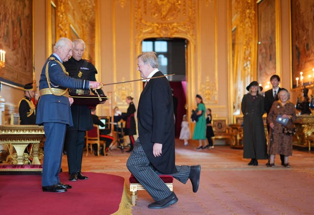 <p>Sir Stephen Fry is knighted by the King</p>