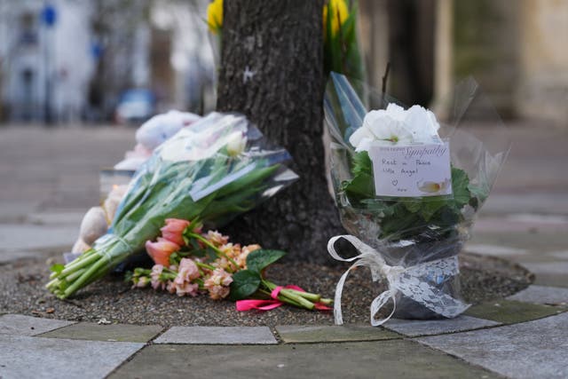 Tributes outside All Saints’ Church in Notting Hill, west London, where a baby’s body was found in a bag on Tuesday (Yui Mok/PA)