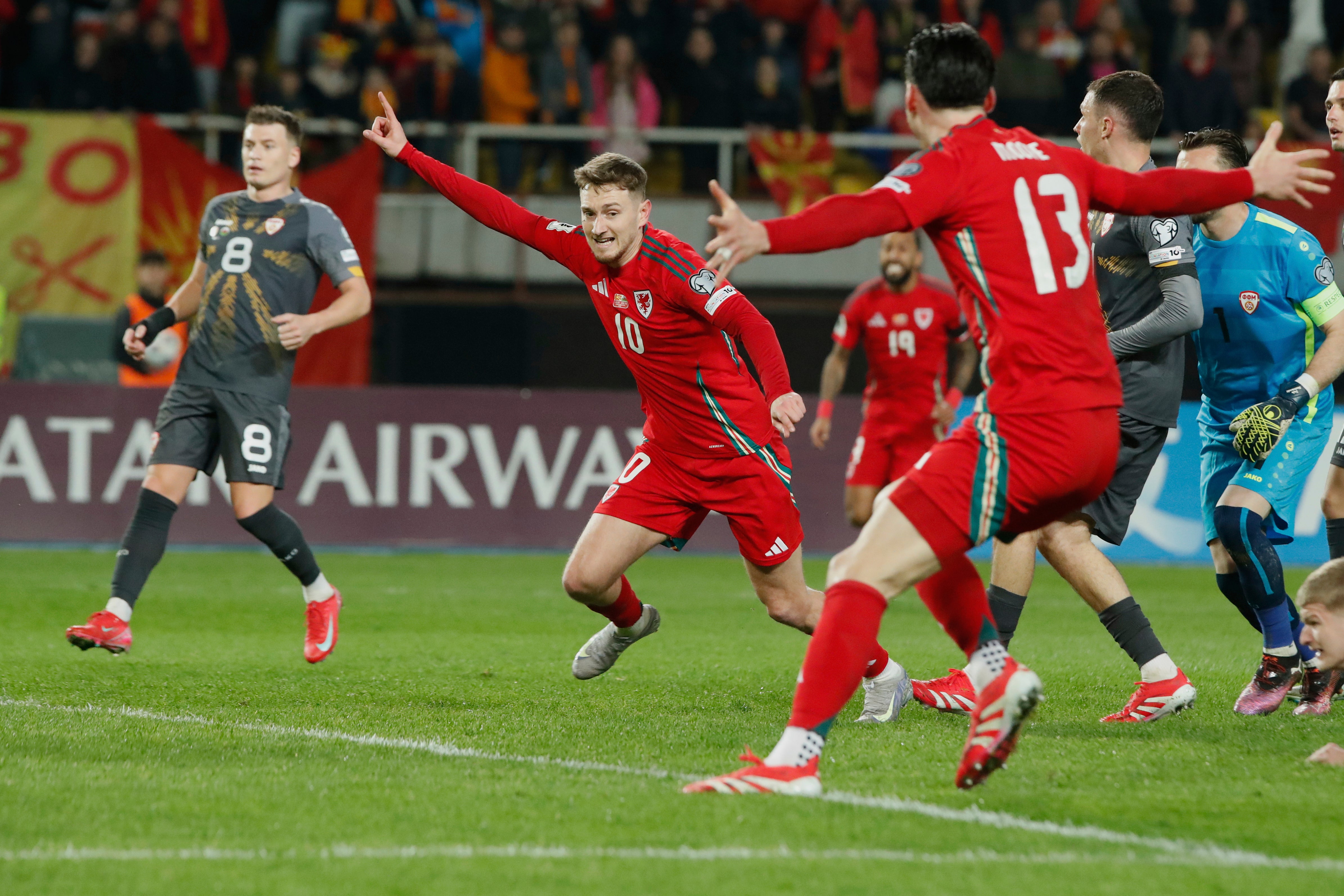 Wales' David Brooks, second left, celebrates with teammates after scoring