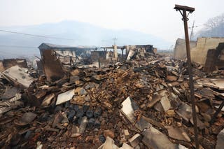 Burned houses in a destroyed village can be found in Chongsung, Korea
