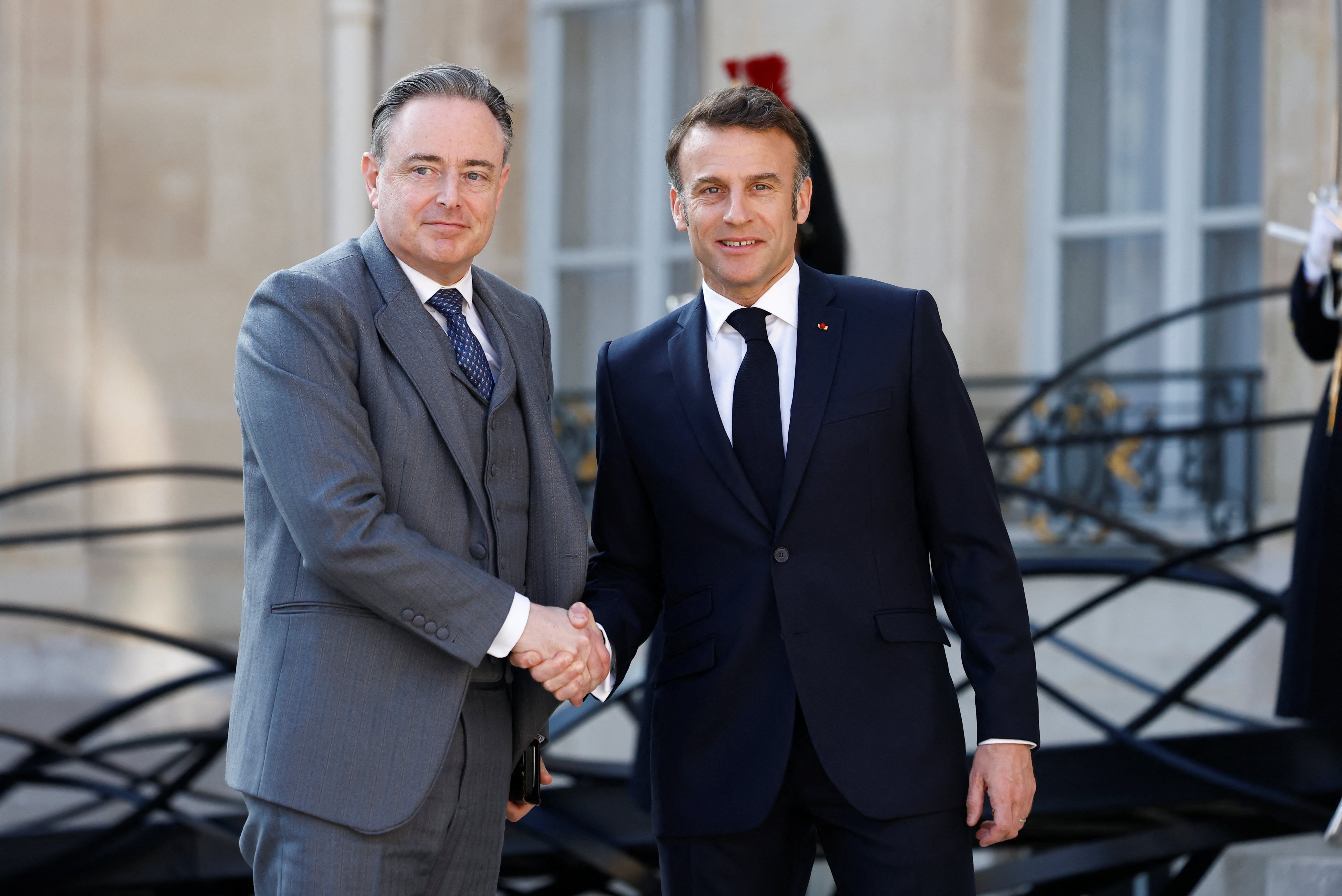 French President Emmanuel Macron shakes hands with Belgian Prime Minister Bart De Wever as he arrives for a meeting with European leaders in Paris
