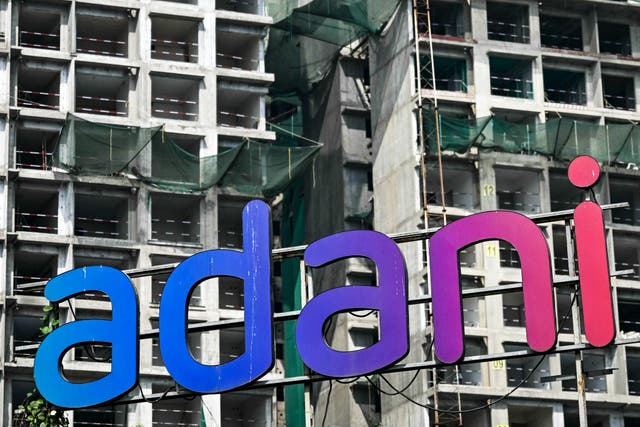 <p>An Adani Group signage is displayed at the construction site of a real estate project by Adani Realty in Mumbai</p>