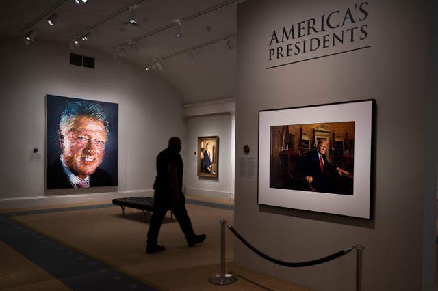<p>A photograph of former US President Donald Trump hangs on the wall at the Smithsonian National Portrait Gallery in Washington, DC, on May 14, 2021</p>