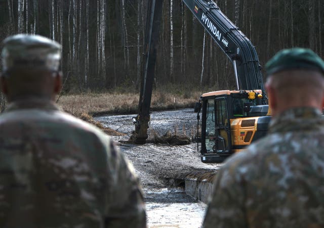 <p>U.S. Army soldiers along with Lithuanian Army and emergency services personnel discuss their plan to recover the soldiers near Pabadre, Lithuania</p>