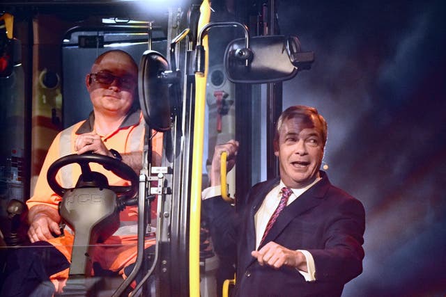 Reform UK leader Nigel Farage arrives on a JCB digger during the Reform UK local election launch rally at the Utilita Arena Birmingham in Birmingham (Jacob King/PA)