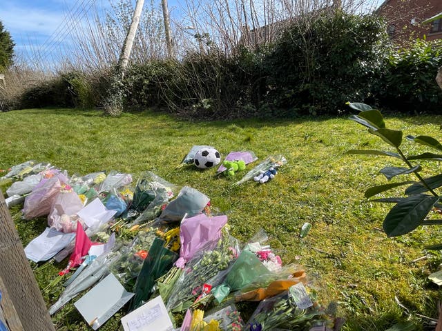 <p>Floral tributes near the scene in Rushton, near Kettering</p>