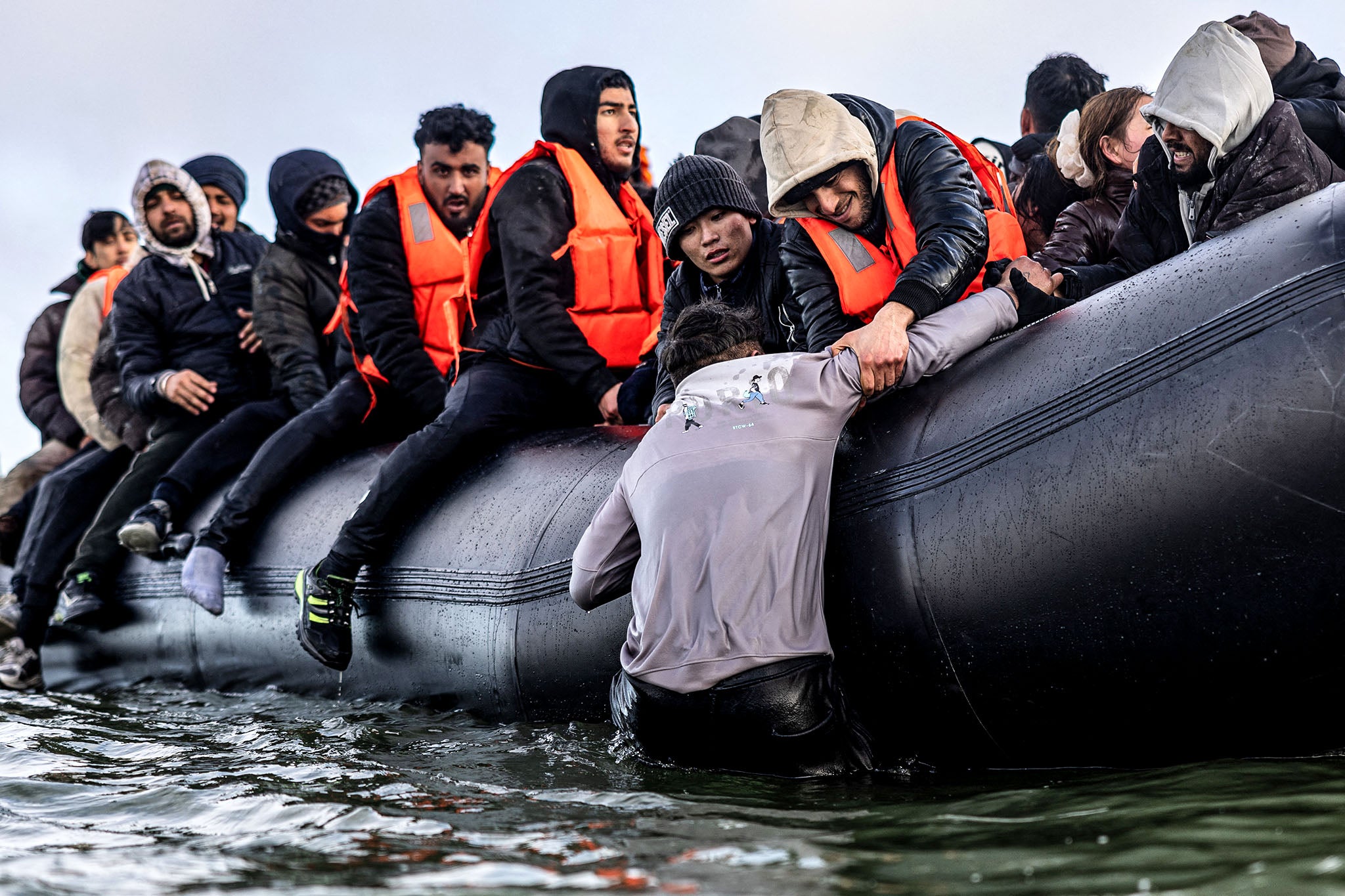 <p>Migrants on board a people smuggler’s boat in the English Channel</p>