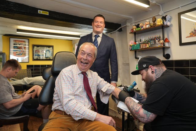 Reform UK leader Nigel Farage and Reform UK mayoral candidate Ryan Coogan visit a tattoo parlour during Reform UK's local election campaign