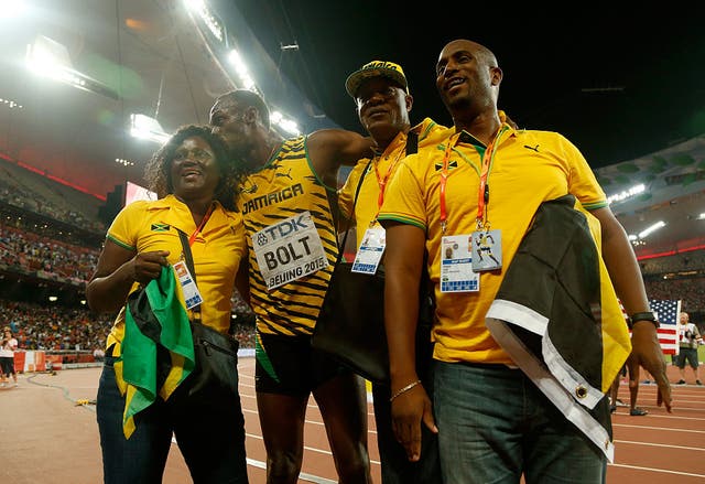 <p>Wellesley Bolt, third from left, often attended major track meets alongside wife Jennifer (left) to cheer on his son</p>