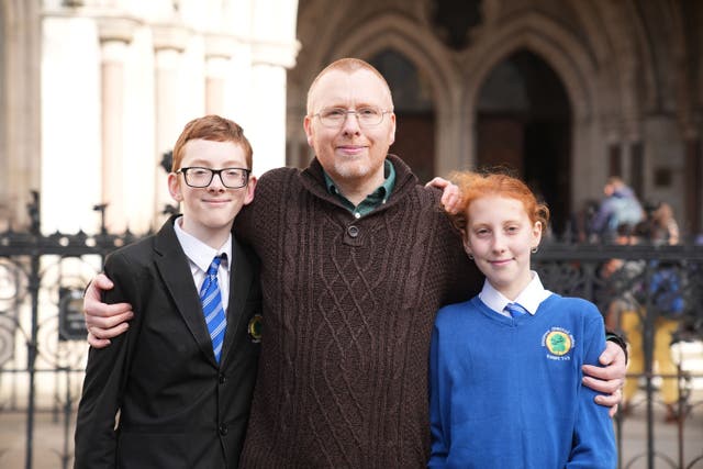Josiah, Stephen White and Joy protest outside the Royal Courts of Justice in London over the private school fees VAT policy (Aaron Chown/PA)