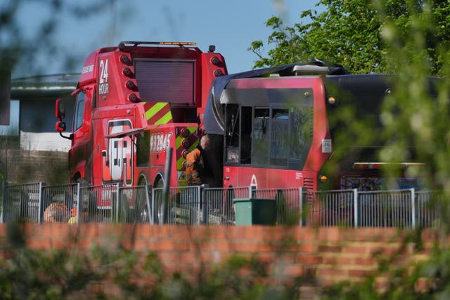 The damaged bus is towed away from the scene of an accident on Belfont Road in Feltham, west London, outside of Feltham Young Offenders Institution (Jonathan Brady/PA)