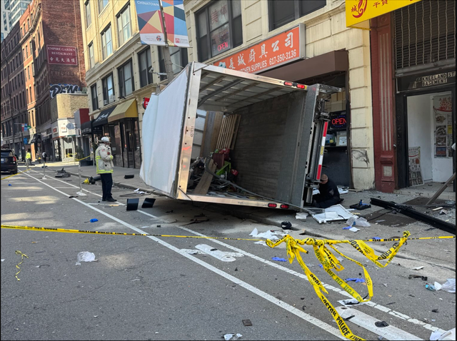 <p>A truck rests against the side of a building in Boston's Chinatown. It crashed into people and left a total of six injured</p>