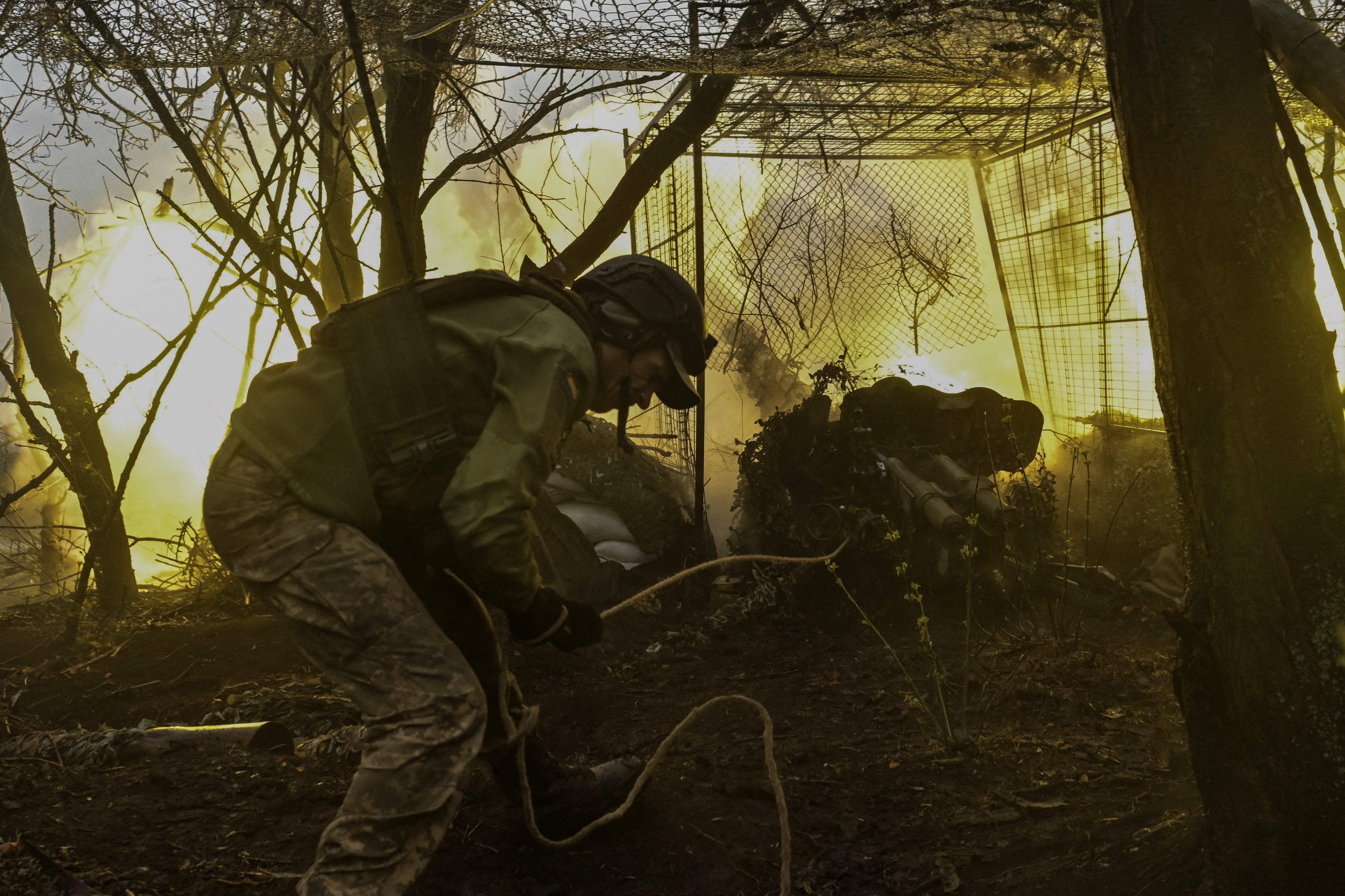<p>A Ukrainian serviceman of the 108th Territorial Defence Forces Brigade fires a D-44 field artillery gun towards Russian troops</p>