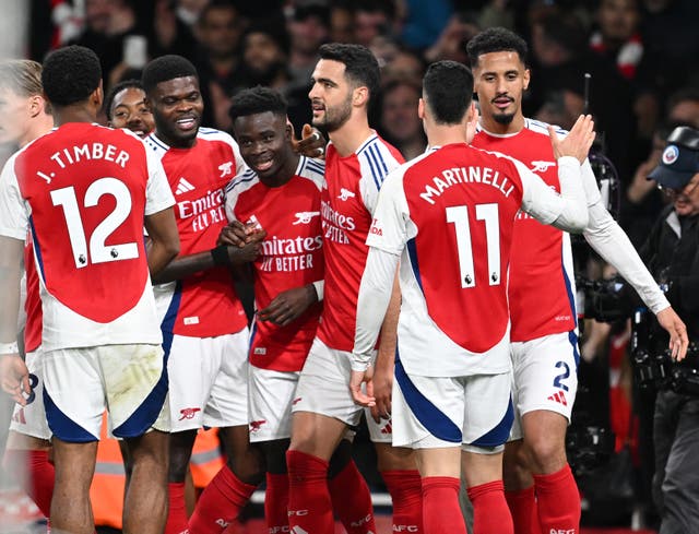 <p>Bukayo Saka celebrates scoring with his Arsenal teammates</p>