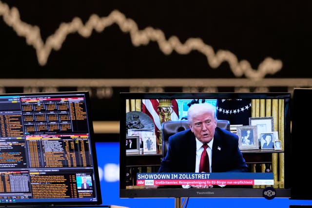 <p>US President Donald Trump appears on a television screen at the stock market in Frankfurt, Germany</p>
