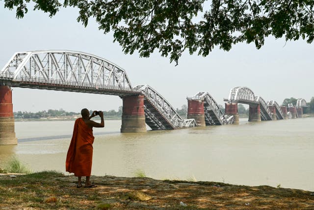 <p>A monk on the banks of the Irrawaddy River in front of the collapsed Ava Bridge, also known as the Inwa Bridge, in Sagaing</p>