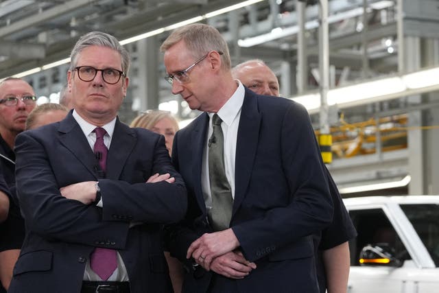 <p>CEO of Jaguar Land Rover, Adrian Mardell (R) speaks with Britain's Prime Minister Keir Starmer (L) during a visit to a Jaguar Land Rover (JLR) car factory in Birmingham, central England on April 7, 2025.</p>