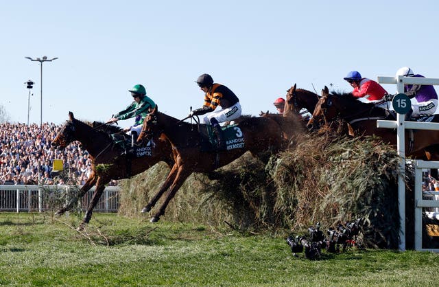 <p>Nick Rockett and Patrick Mullins on their way to winning the Grand National</p>