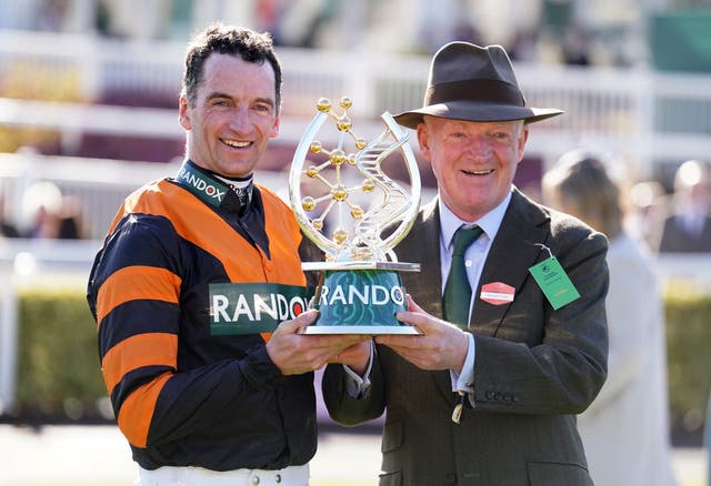 <p>Patrick (left) and Willie Mullins celebrate winning the 2025 Grand National</p>