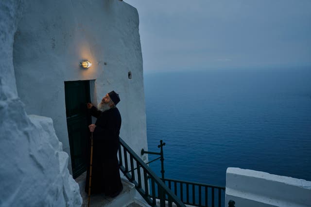 <p>Orthodox Christian monk Father Spyridon locks the chapel of the Monastery of Panagia Hozoviotissa</p>