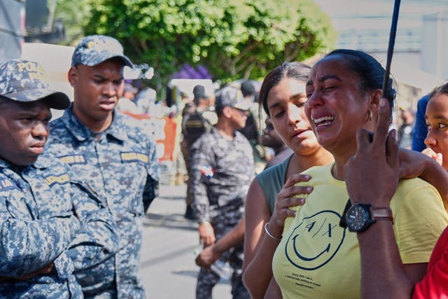 <p>Relative of a missing person is comforted by a friend outside Jet Set nightclub after its roof collapsed during a merengue concert in Santo Domingo</p>