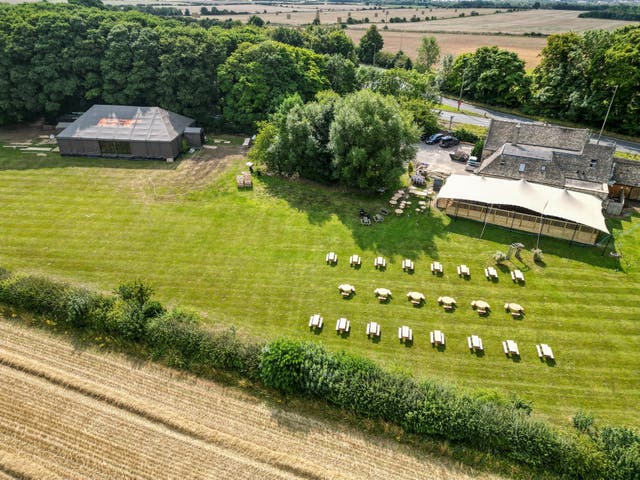 <p>Drone photos show seats and a cover of the outdoor area at The Windmill near the village of Burford in Oxfordshire</p>