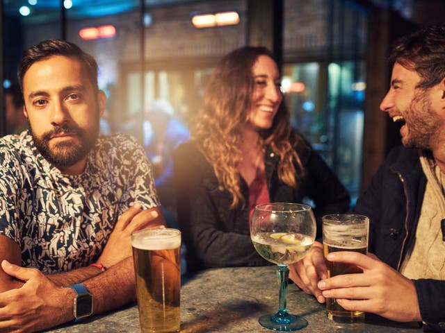 <p>Third wheeling: A man looks bored having drinks with a couple</p>
