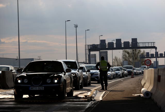 <p>Cars drive through a disinfectant mat during the outbreak of foot-and-mouth disease at the Austrian-Hungarian border</p>