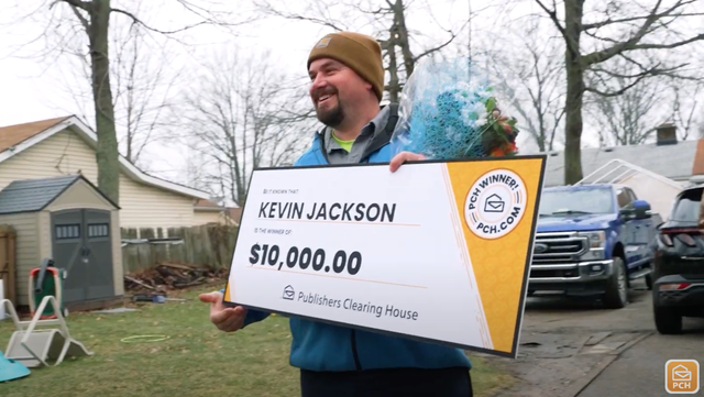 <p>Publishers Clearing House sweepstakes winner is presented with a check</p>