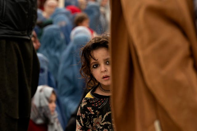 <p>An Afghan girl waits in a queue to receive a free iftar meal on the outskirts of Kabul</p>