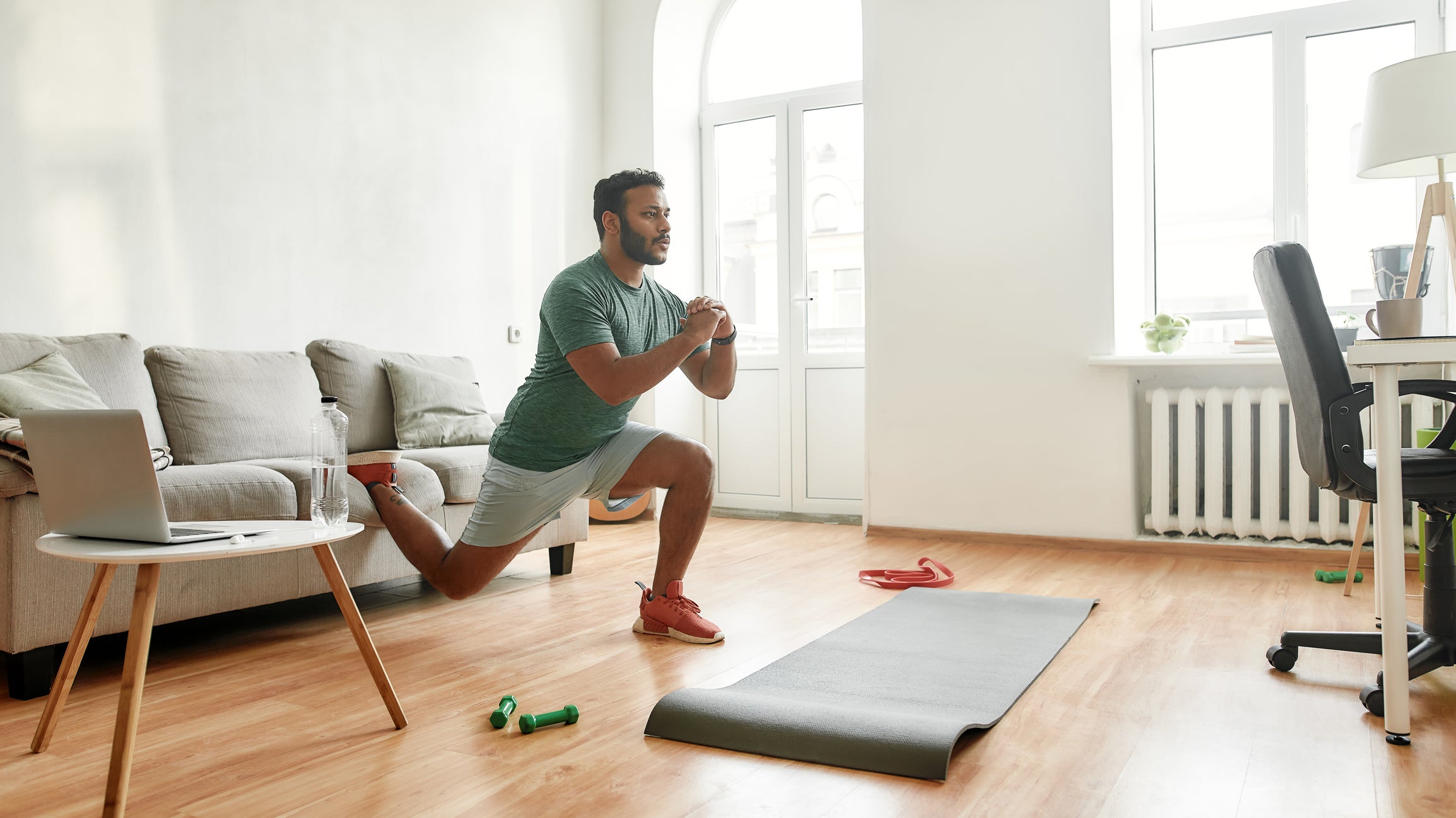A man performing a Bulgarian split squat during a home workout