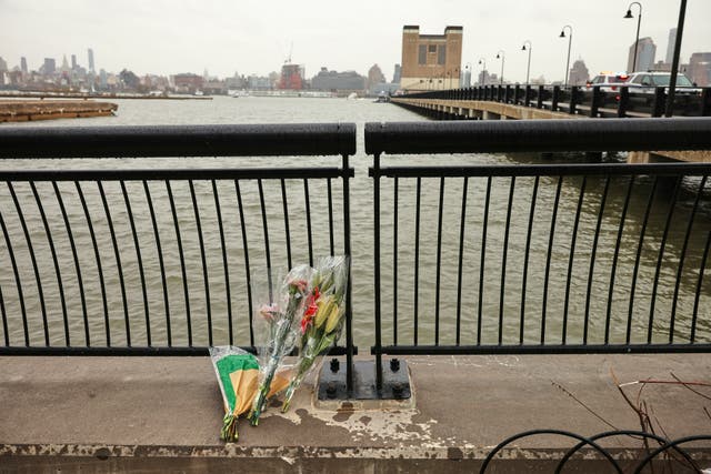 <p>Flowers rest at the end of a pier, Friday, 11 April 2025, near the site where a sightseeing helicopter crashed into the Hudson River in Jersey City, N.J</p>