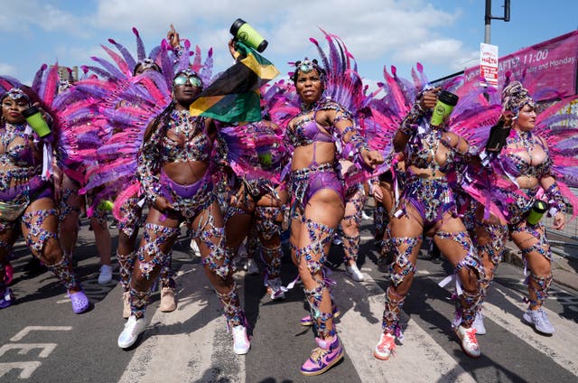<p>Dancers prepare to take part in 2024’s Notting Hill Carnival (Lucy North/PA)</p>