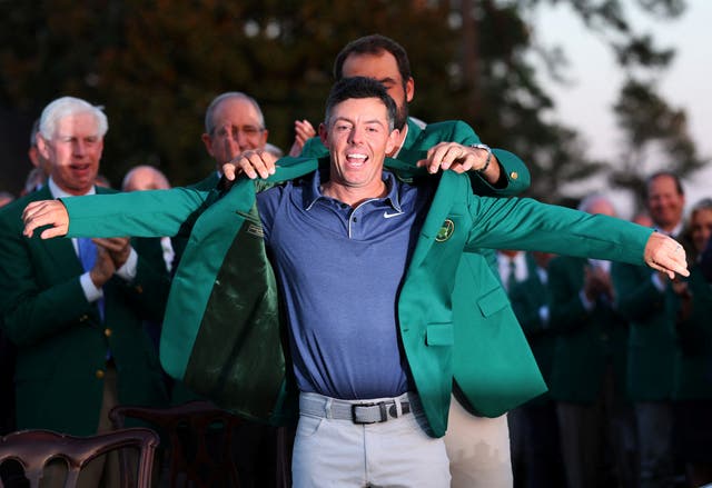 <p> Northern Ireland's Rory McIlroy is presented with the green jacket by Scottie Scheffler of the U.S. after winning The Masters and completing a career grand slam </p>