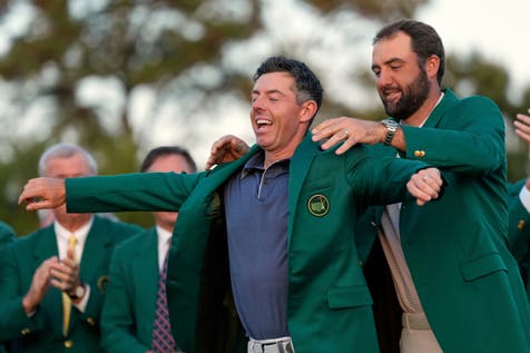 <p>Scottie Scheffler puts the green jacket on new Masters champion Rory McIlroy (Ashley Landis/AP)</p>