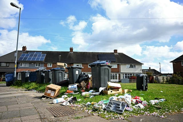 <p>Waste spills from overflowing and uncollected wheelie bins in the Shard End suburb of Birmingham</p>