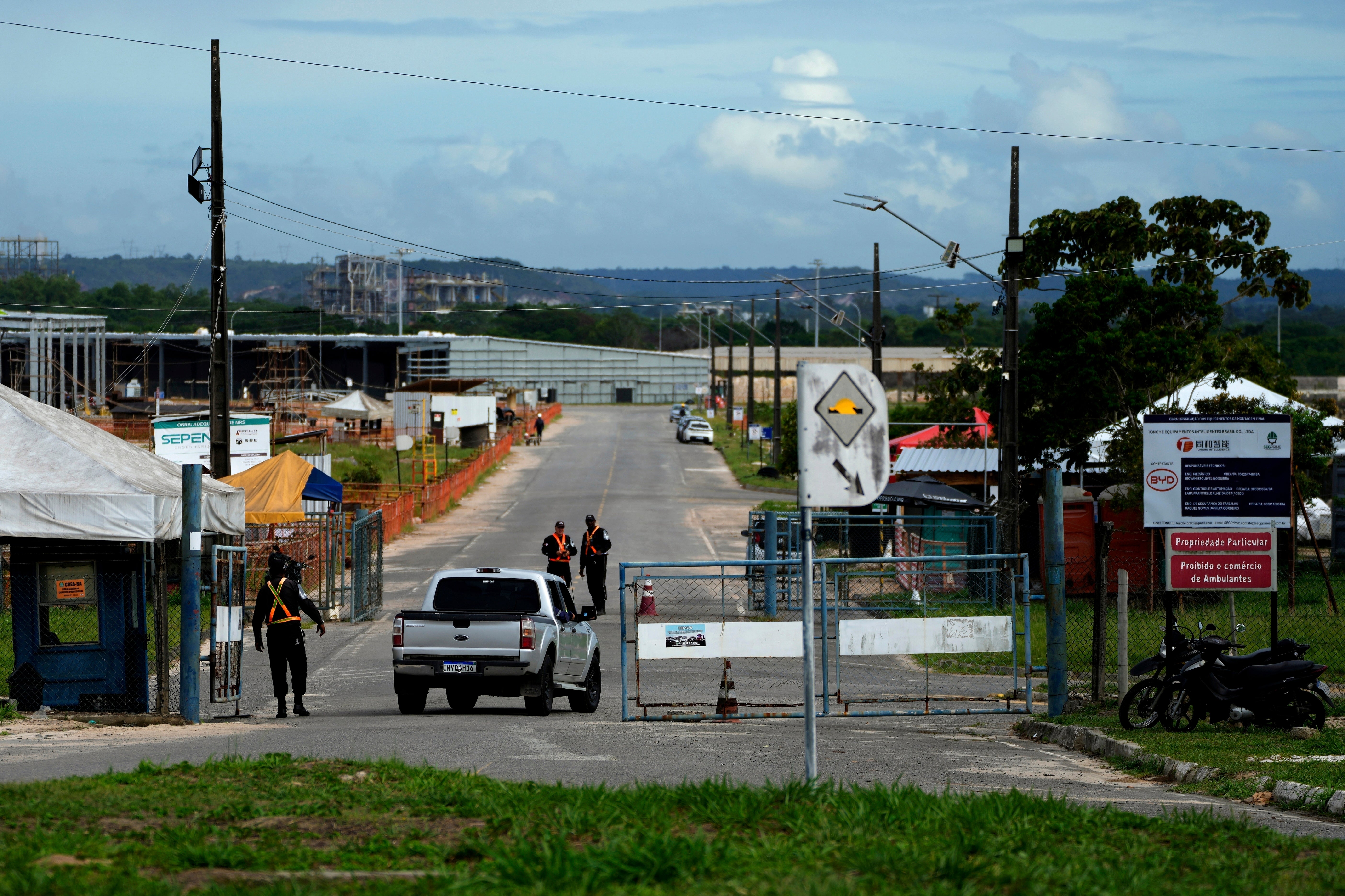Security guards control access to a BYD factory being built in Camacari, Brazil, on 6 March 2025