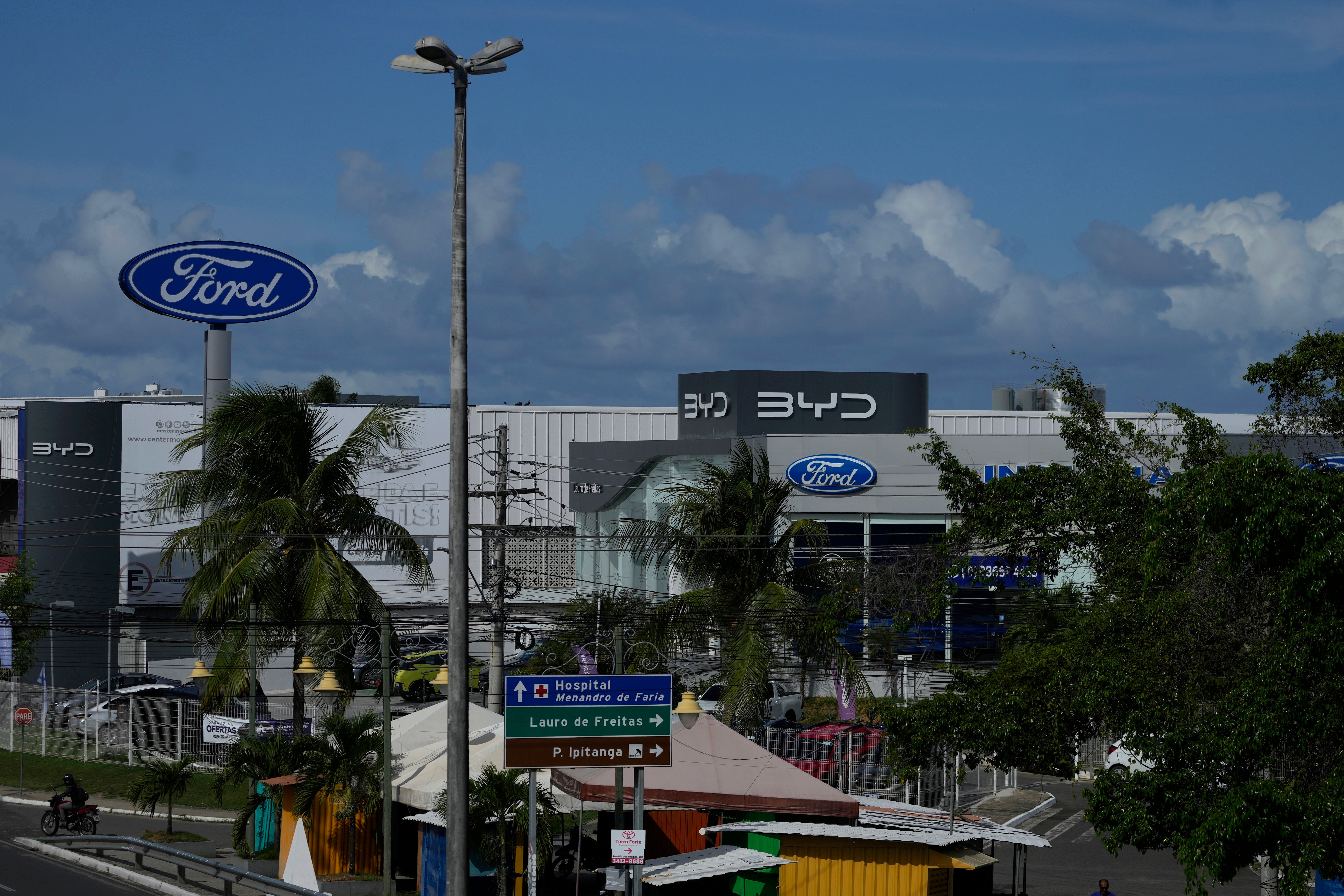 Signs are displayed for BYD and Ford dealerships in Camacari, Brazil, on 7 March 2025