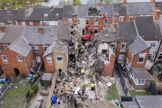 <p>The length of the house was wrecked, with debris covering the street and back garden</p>