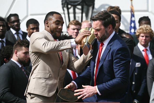 <p>Running back TreVeyon Henderson (L) and US Vice President JD Vance bobble the College Football Playoff National Championship Trophy as US President Donald Trump hosts the 2025 College Football National Champions, Ohio State Buckeyes</p>